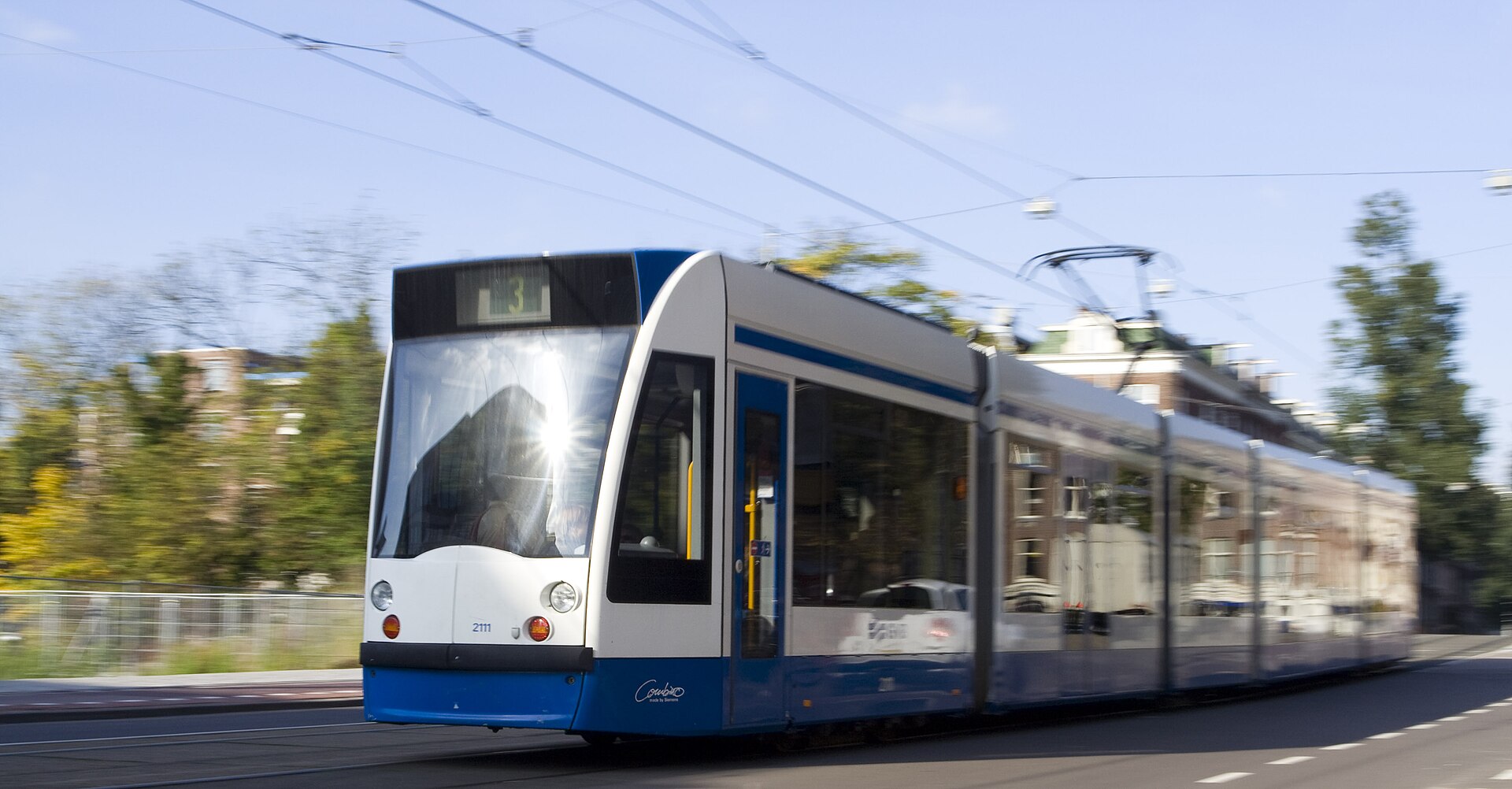 A blue-and-white GVB tram on an Amsterdam street